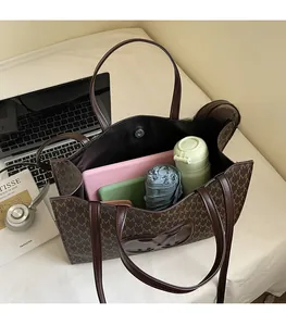 Top view of large tote bag interior showing capacity for laptop, bottle and umbrella