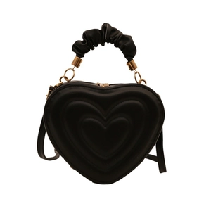 Black heart-shaped handbag with quilted pattern and pleated silk handle with gold rings