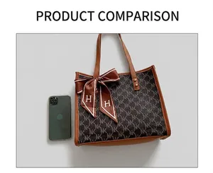 Detailed view of monogram tote bag with brown leather trim and silk scarf detail