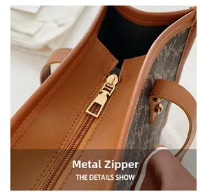 Large vintage brown tote bag with premium leather trim and golden metal zipper detail