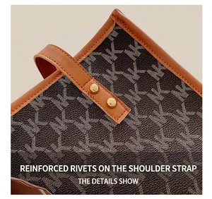 Close-up of the reinforced metal rivets and leather stitching on the NK patterned tote bag