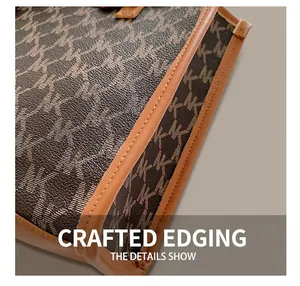 Close-up of premium stitching and leather trim on a patterned canvas tote bag