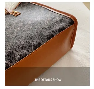 Detailed close-up of dark monogram canvas with premium brown leather stitching on tote bag