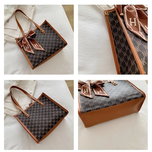 Detailed views of a large capacity tote bag with logo prints and silk scarf decor