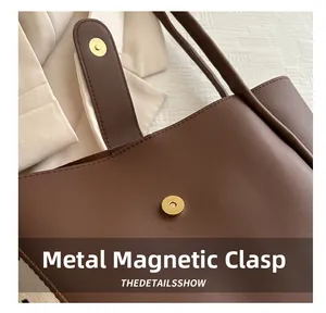 Detail of the high-quality hardware magnetic snap on a brown minimalist tote bag