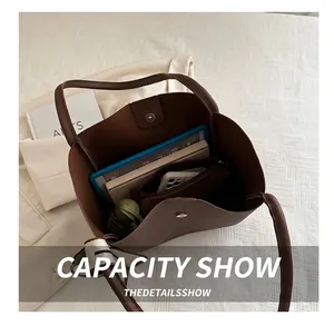 Top view of large brown leather tote bag interior showing spacious capacity and magnetic clasp