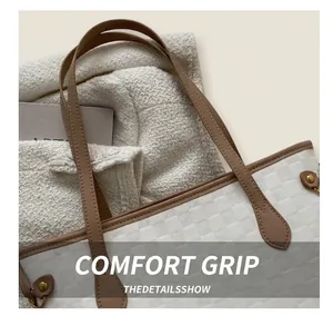 Detail of white tote bag featuring checkered texture with brown leather handles