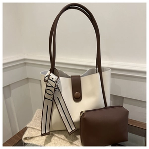Detail of minimalist tote bag set with LOVE jacquard ribbon and magnetic closure