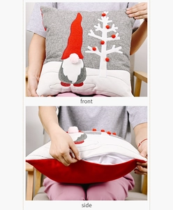 Detail of Christmas gnome pillowcase with grey embroidery and red pom-poms on the front
