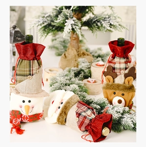 Detail of Christmas wine bottle bags with snowman, Santa, and reindeer fabric designs