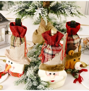 Detail of Christmas wine bottle covers featuring linen fabric and cute cartoon characters