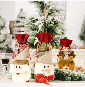 Detail of linen Christmas wine bottle covers with Santa, Snowman and Reindeer motifs