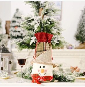 Detailed view of snowman wine bottle cover with red plaid scarf and wood buttons