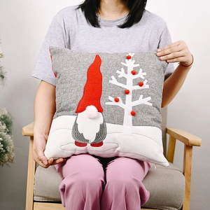 Grey Christmas gnome pillow cover with plush tree and pom-poms on linen texture