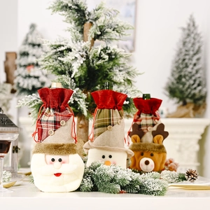 Three-piece burlap Christmas wine bottle covers with Santa, Snowman and Reindeer designs