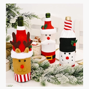 Close-up of knitted Christmas wine bottle covers with Santa, reindeer, and snowman motifs