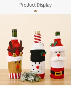 Detailed view of three festive knitted wine bottle covers on a decorated dining table