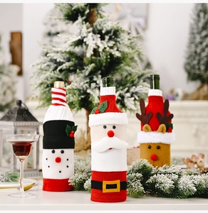 Detailed close-up of knitted Santa and Reindeer wine bottle covers for Christmas decor
