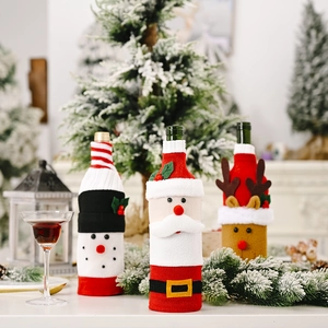 Three festive Christmas wine bottle covers featuring Santa, snowman, and reindeer designs