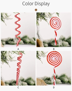 Detail shots of red and white acrylic Christmas ornaments on snowy pine branches