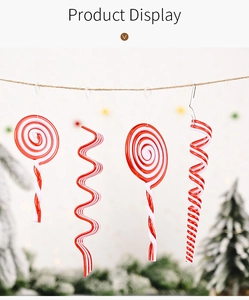 Detail of red and white striped Christmas candy ornaments hanging on a rustic rope