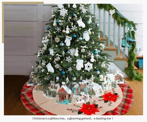 Detail of burlap Christmas tree skirt with red poinsettia and plaid edge decoration