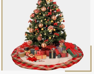 Close-up of a Christmas tree skirt with red flower and green plaid edges in a festive room