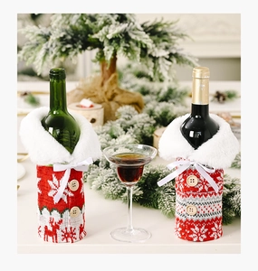 Detail of Christmas wine bottle covers featuring knit snowflake patterns and fur collars