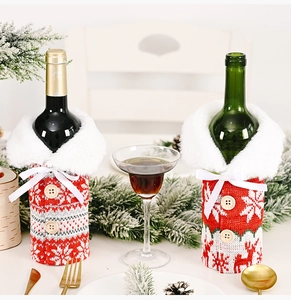 Macro detail of Christmas knitted wine bottle covers with white fur collars and wooden buttons