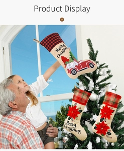 Detailed view of burlap Christmas stockings featuring gnomes, red trucks, and poinsettia