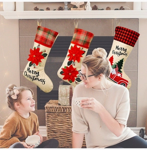 Detail of burlap Christmas stockings set with red truck and festive floral patterns