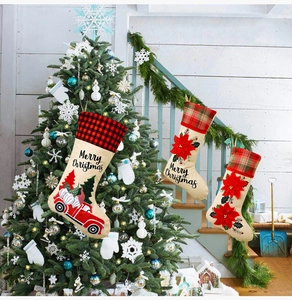 Three-piece burlap Christmas stockings featuring vintage red truck and gnome holiday patterns