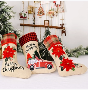 Three burlap Christmas stockings with 3D red flowers and plaid trim for home decoration