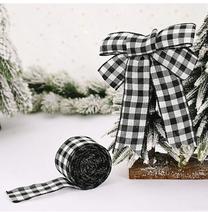 Detail of 2M black and white gingham ribbon roll and a bow in a festive snowy scene