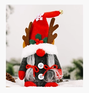 Close-up of Christmas gnome plush with red knit hat, reindeer antlers, and gray beard detail