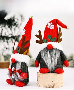 Detail of Christmas gnomes with reindeer antlers and snowflakes on a snowy wooden base