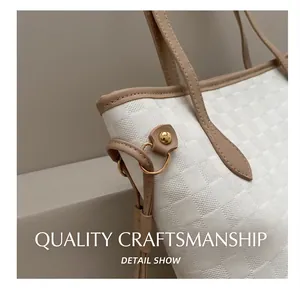 Close-up of beige checkerboard woven texture tote with khaki leather trim and gold rings