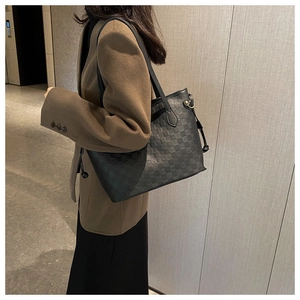 Detailed view of black tote bag with checkered embossing and adjustable side drawstrings