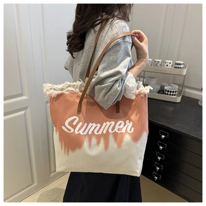 Detail of coral and white canvas tote with Summer print and fringe edges