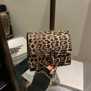 Vintage leopard print crossbody bag with gold chain strap and elegant metal lock closure
