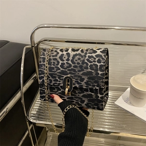 Fashionable leopard print shoulder bag with gold chain strap and metal swivel lock closure