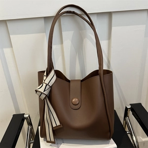 Brown matte PU leather tote bag with round buckle closure and striped silk scarf accessory