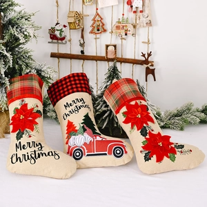 Three-piece burlap Christmas stockings set with poinsettia flowers and gnome truck prints