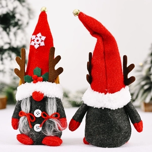 Christmas gnomes with reindeer antlers and festive snowflakes on a winter pine background