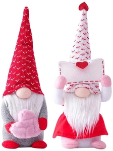Close-up of Valentine gnome plush dolls holding heart envelope and sign for decor