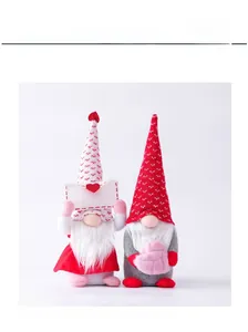 Detail of couple faceless gnomes with knit hats holding envelope and pink plush heart
