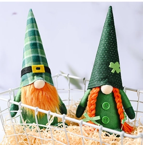 Dettaglio di gnomi di San Patrizio con barbe arancioni e trifogli in un cesto di metallo