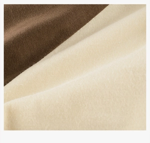 Close-up of soft cotton knit fabric texture in dark brown and light beige colors