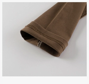 Detail shot of brown long-sleeve cotton T-shirt cuff with durable double-needle stitching