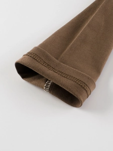 Close-up of children's cotton long sleeve T-shirt showing cuff double-stitching detail